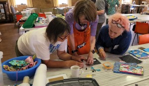 Sewaid teacher and Rotarian Tina Latham, shows how to construct a purse